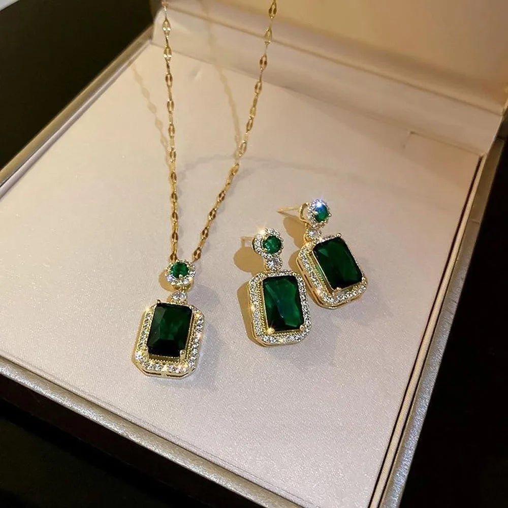 Jewelry set with green gemstones on a white box