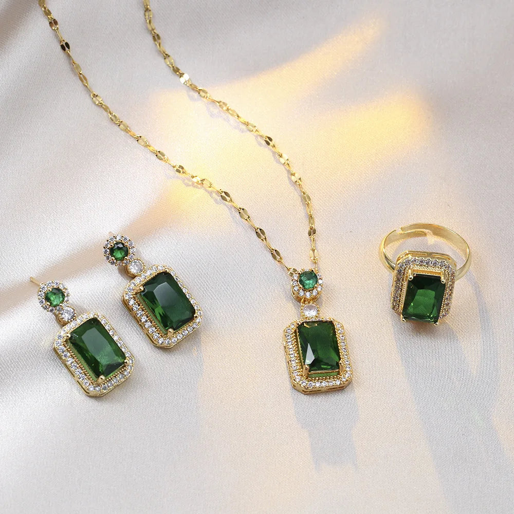 Jewelry set with green gemstones on a white background