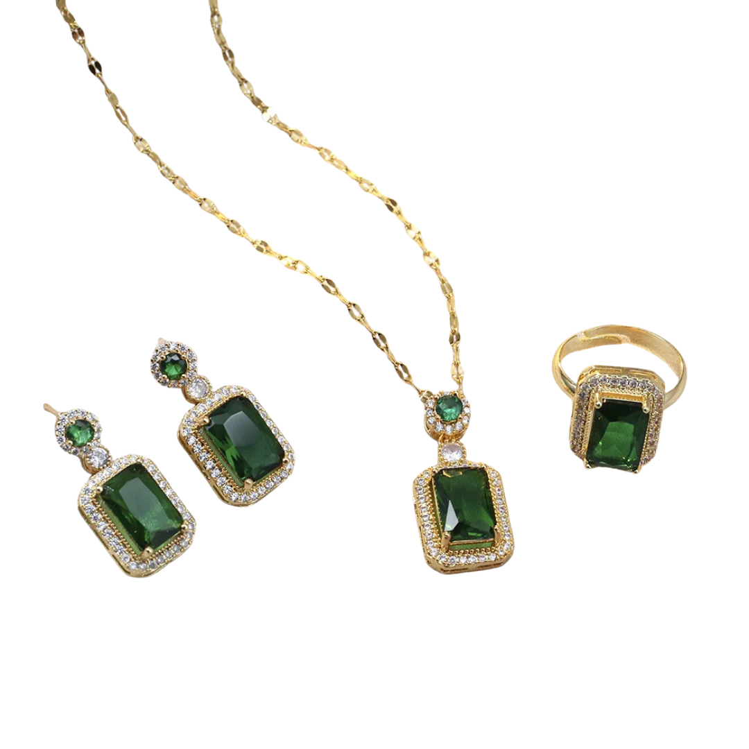 Jewelry set with green gemstones and gold accents on a white background